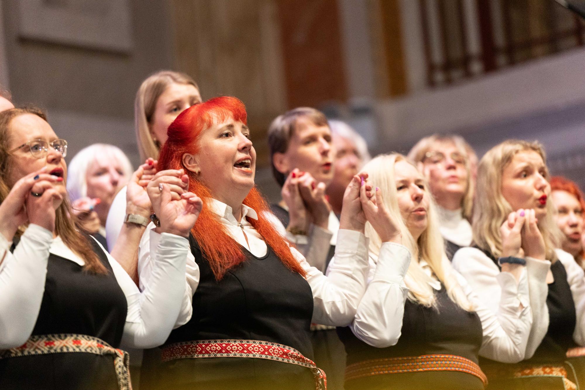 Members of the Gaudete choir sing hand in hand on the stage of Cork City Hall during the closing gala concert.